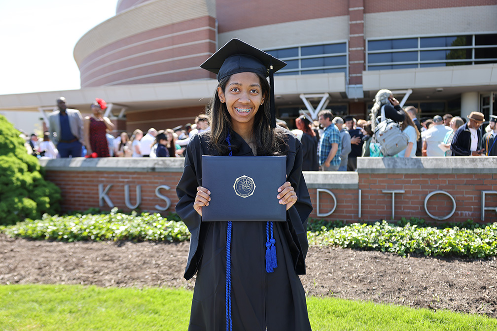 CCP student holding diploma at graduation