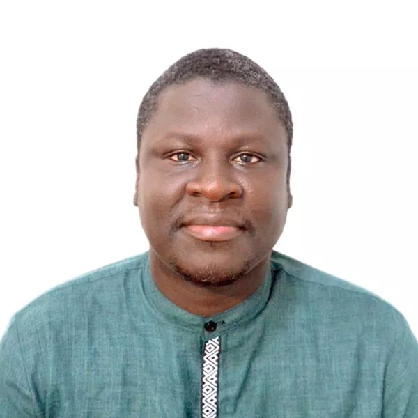 African American male wearing teal button down shirt.