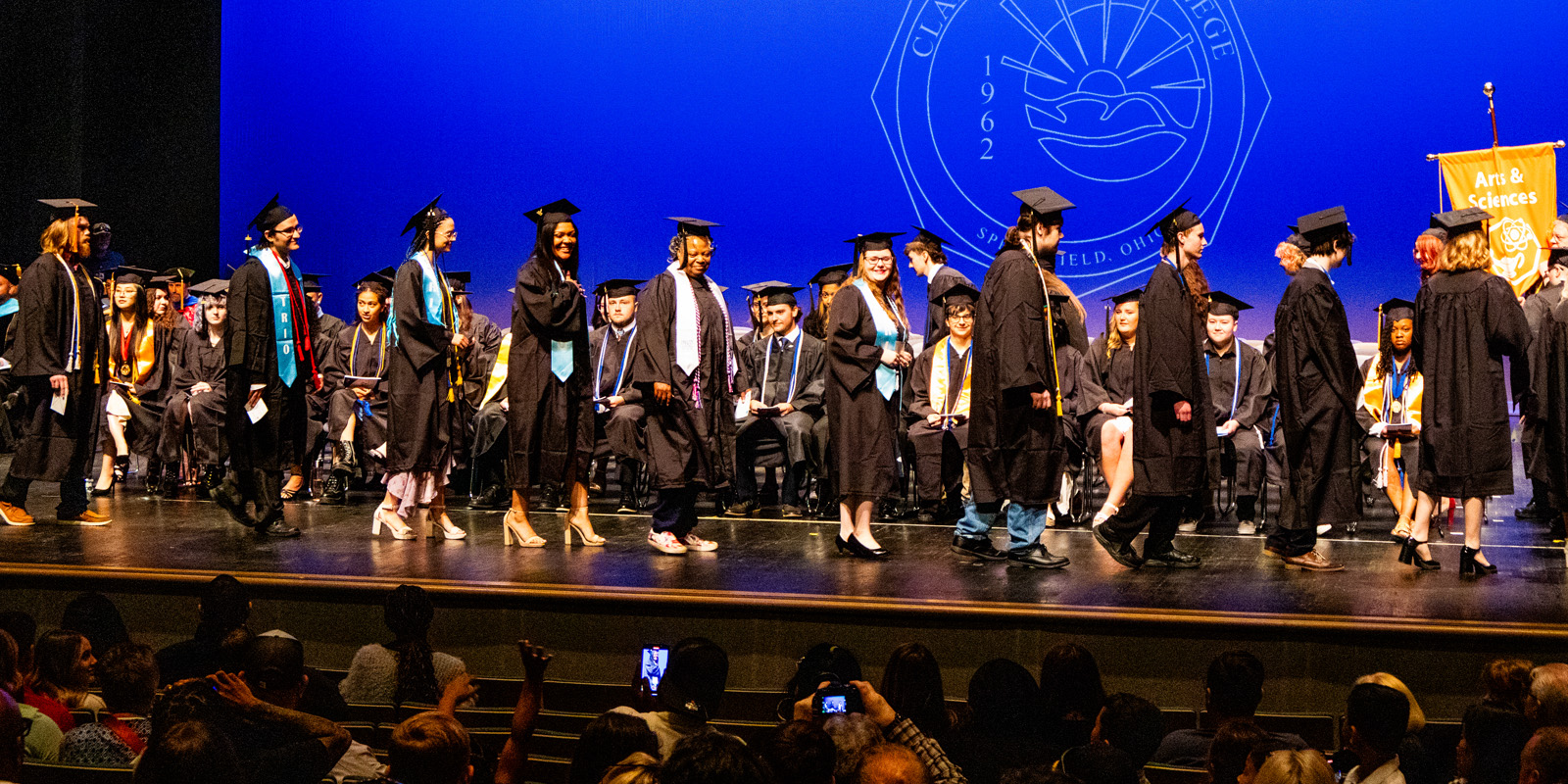 Students walking across stage at graduation