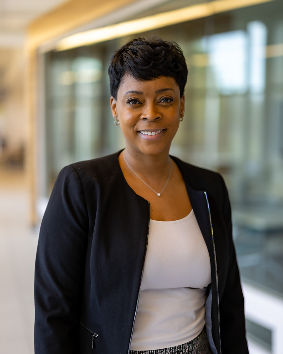 Crystal Jones wearing a white shirt with a black blazer smiling.