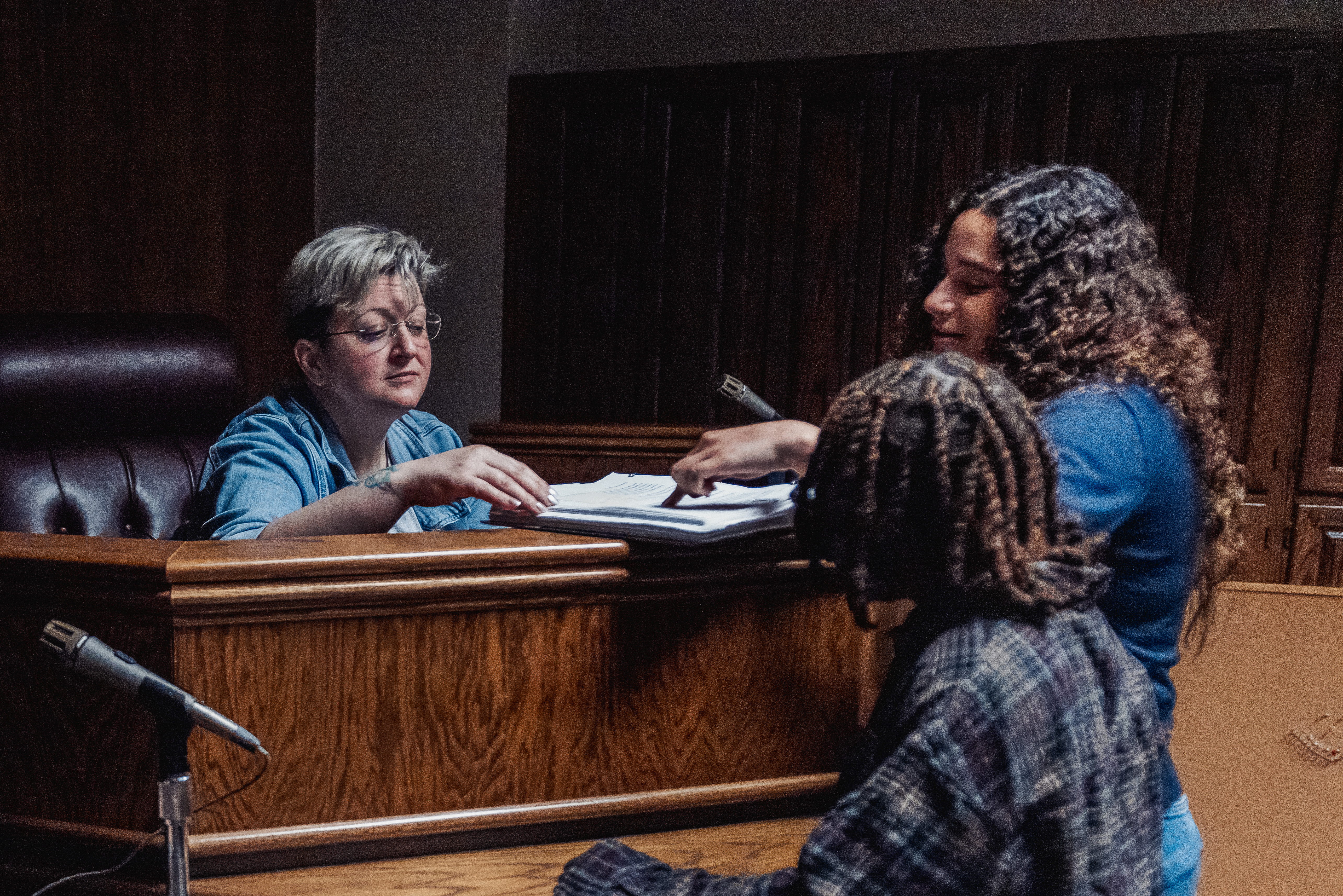 Students participating in a mock courtroom exercise with an instructor at the judge’s bench.