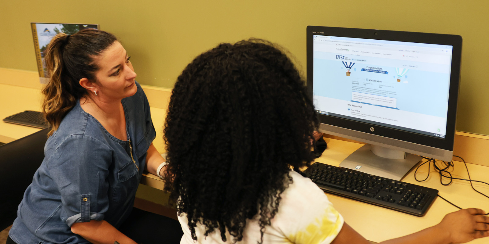 Student working on FAFSA app on a computer