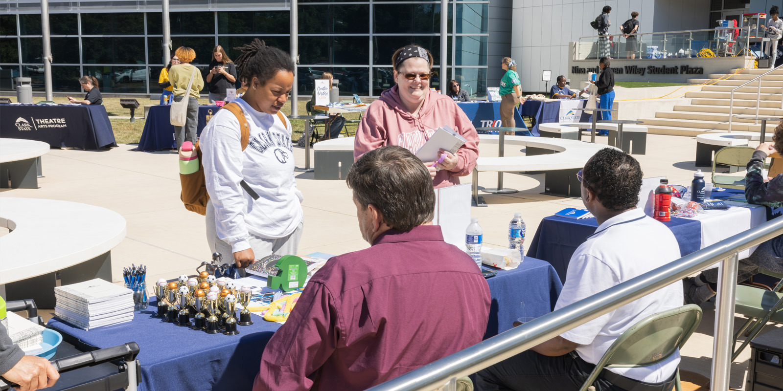 Student learning about a club at an event