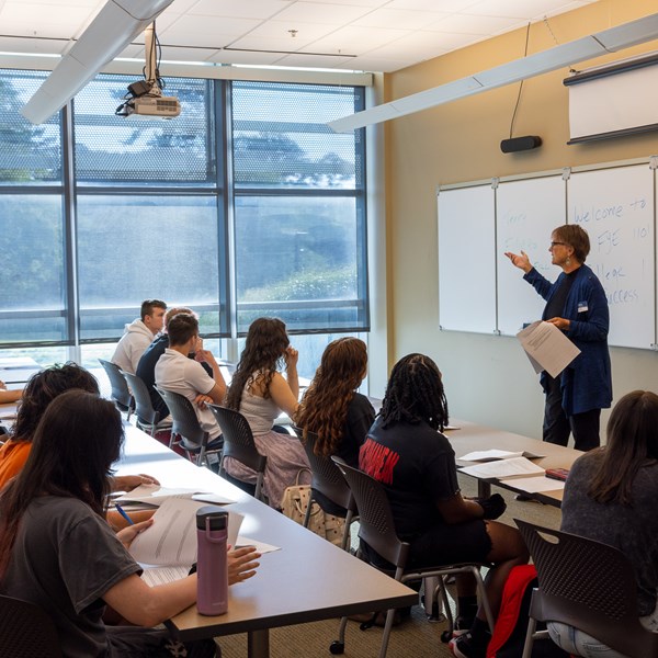 Teacher standing in front of classroom and students