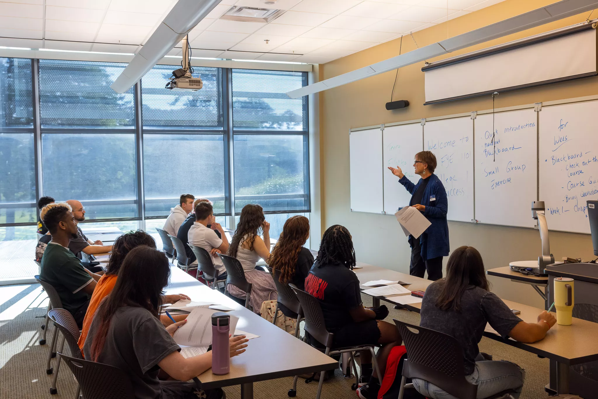 Teacher standing in front of classroom and students