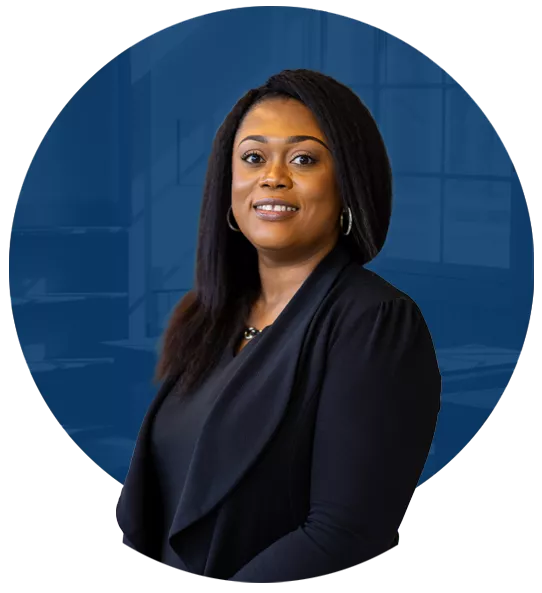 Gigi Minter, a person with straight brown hair wearing a black blouse and cardigan.