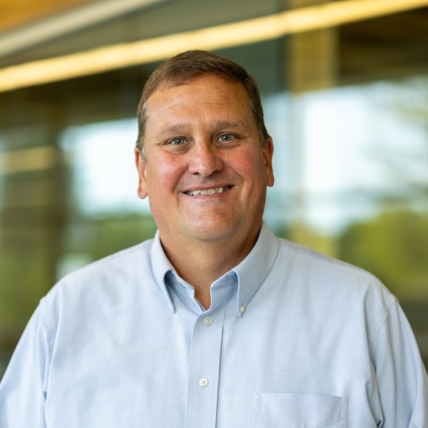 Smiling white male in light blue button down shirt