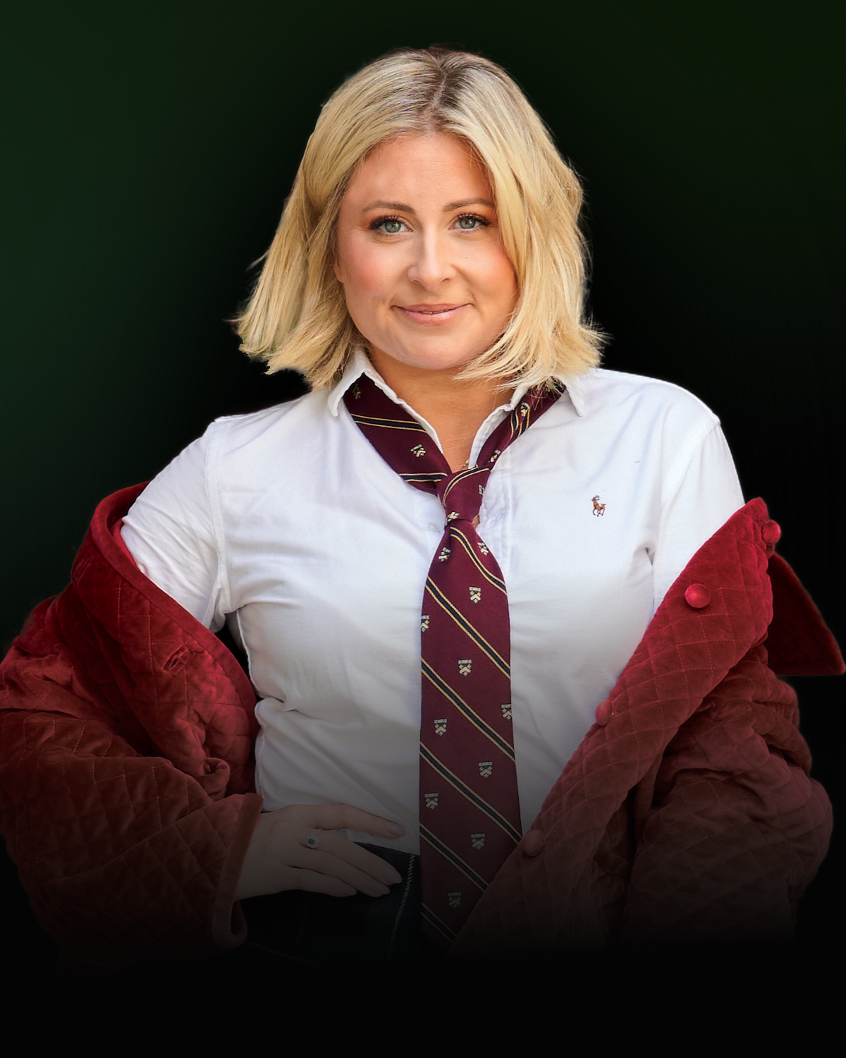 Woman with blonde hair wearing a white shirt, red tie and red sweater