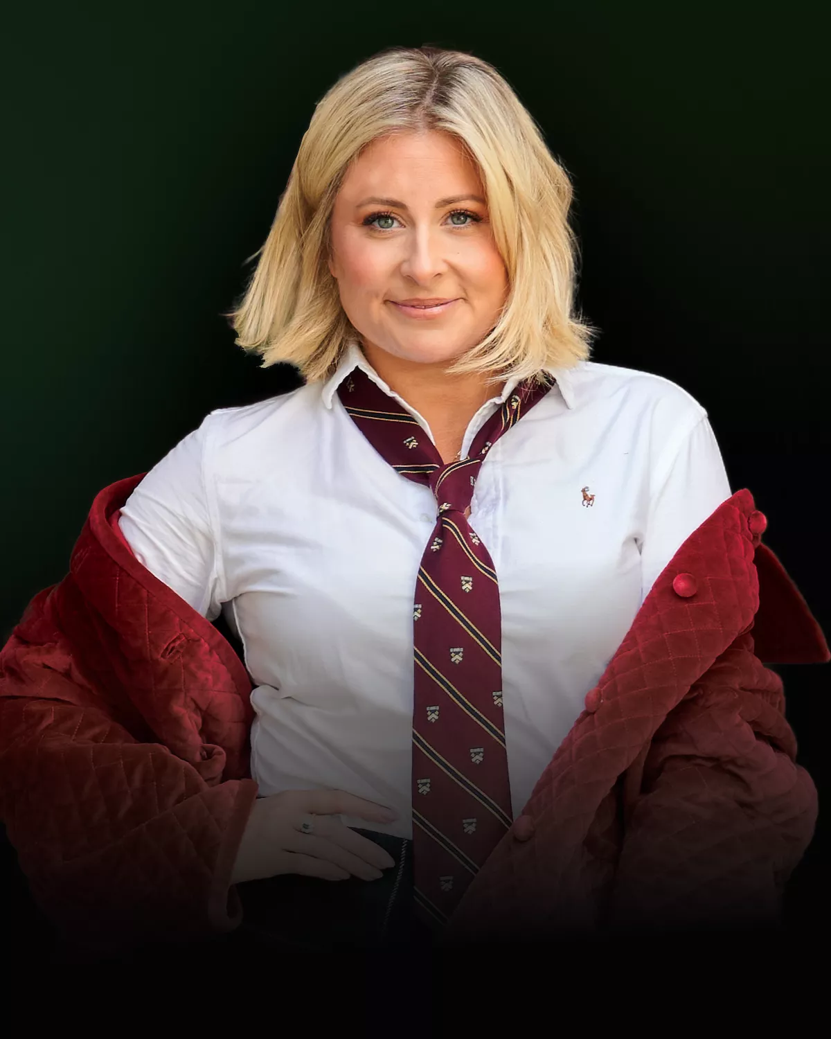 Woman with blonde hair wearing a white shirt, red tie and red sweater