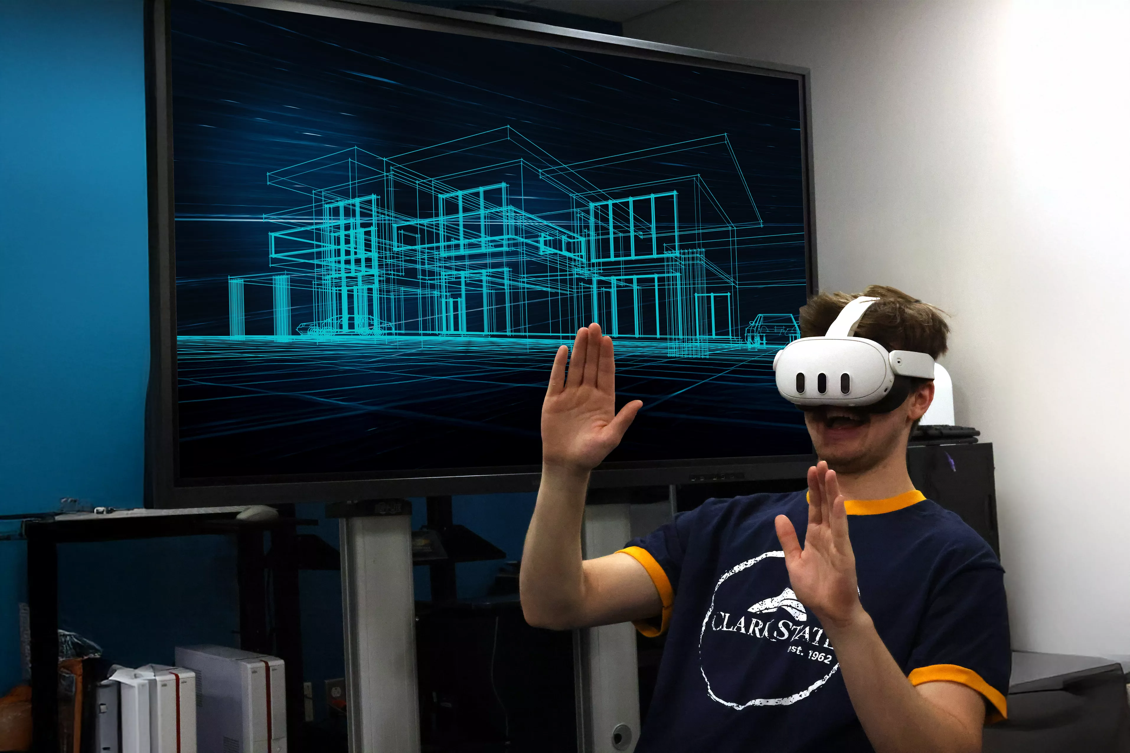 Man wearing virtual reality headset with digital building image on the tv behind him.