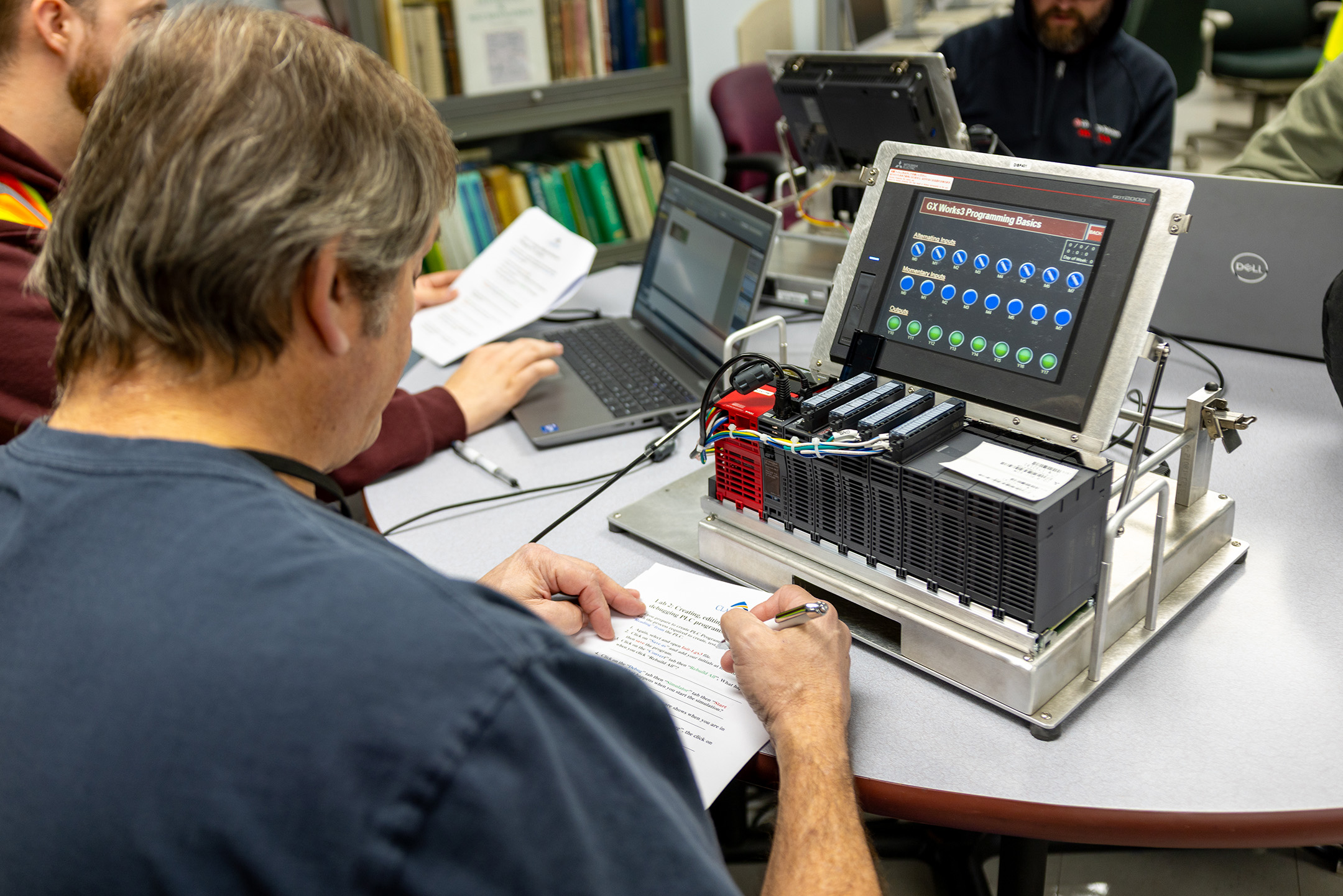 Student working on a piece of electrical equipment.