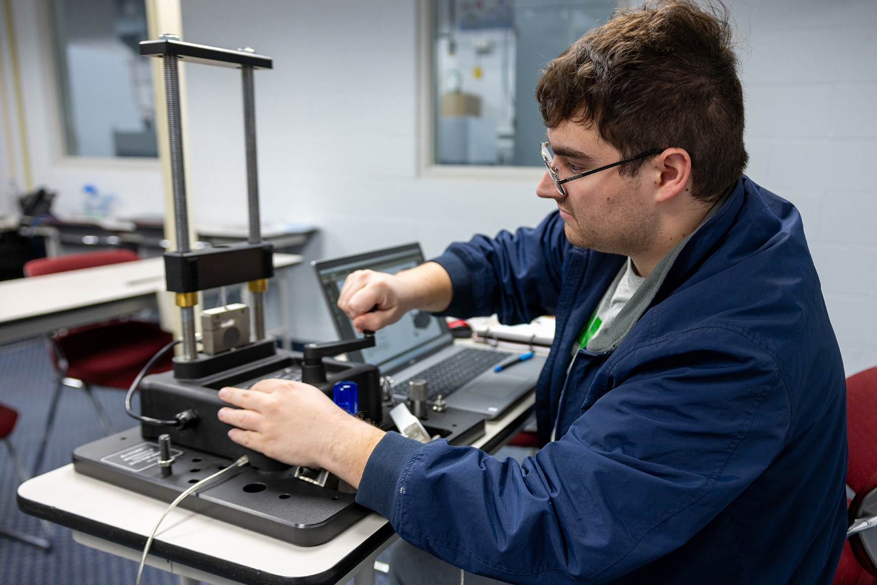 Student working with manufacturing equipment.