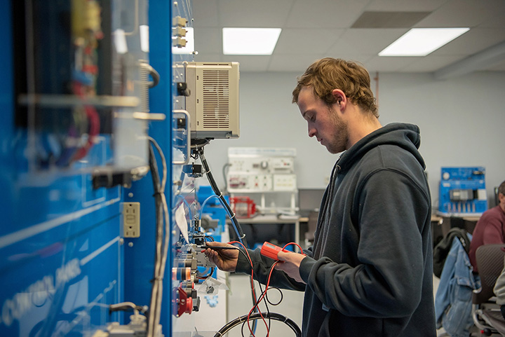 Student working with manufacturing equipment