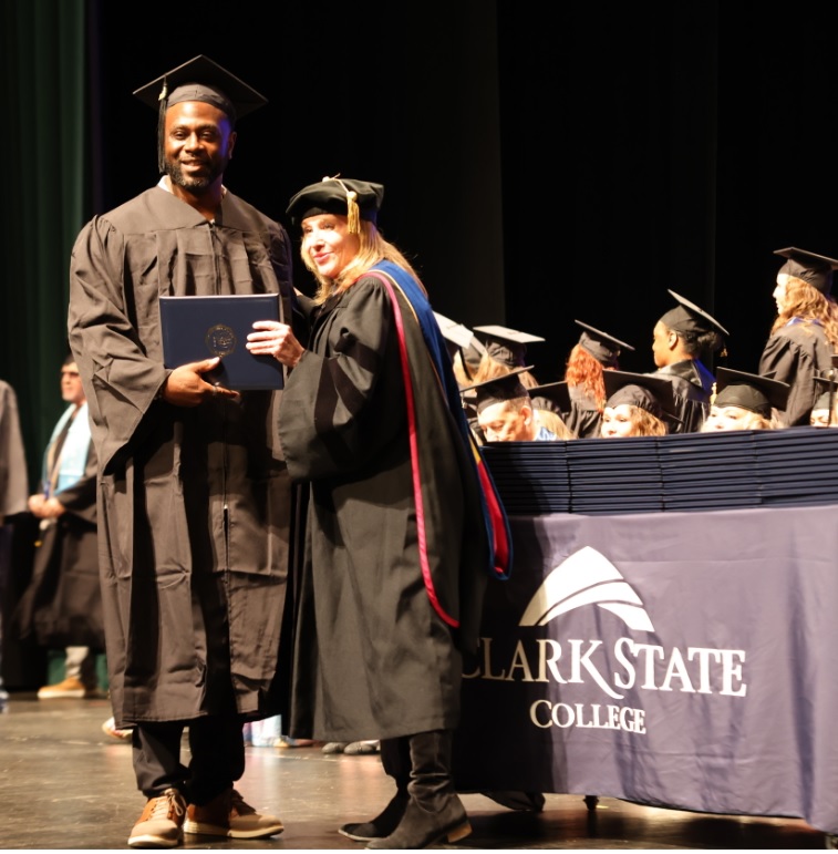 Jo Alice Blondin, Ph.D., Clark State president, awards a diploma to a 2025 graduate.