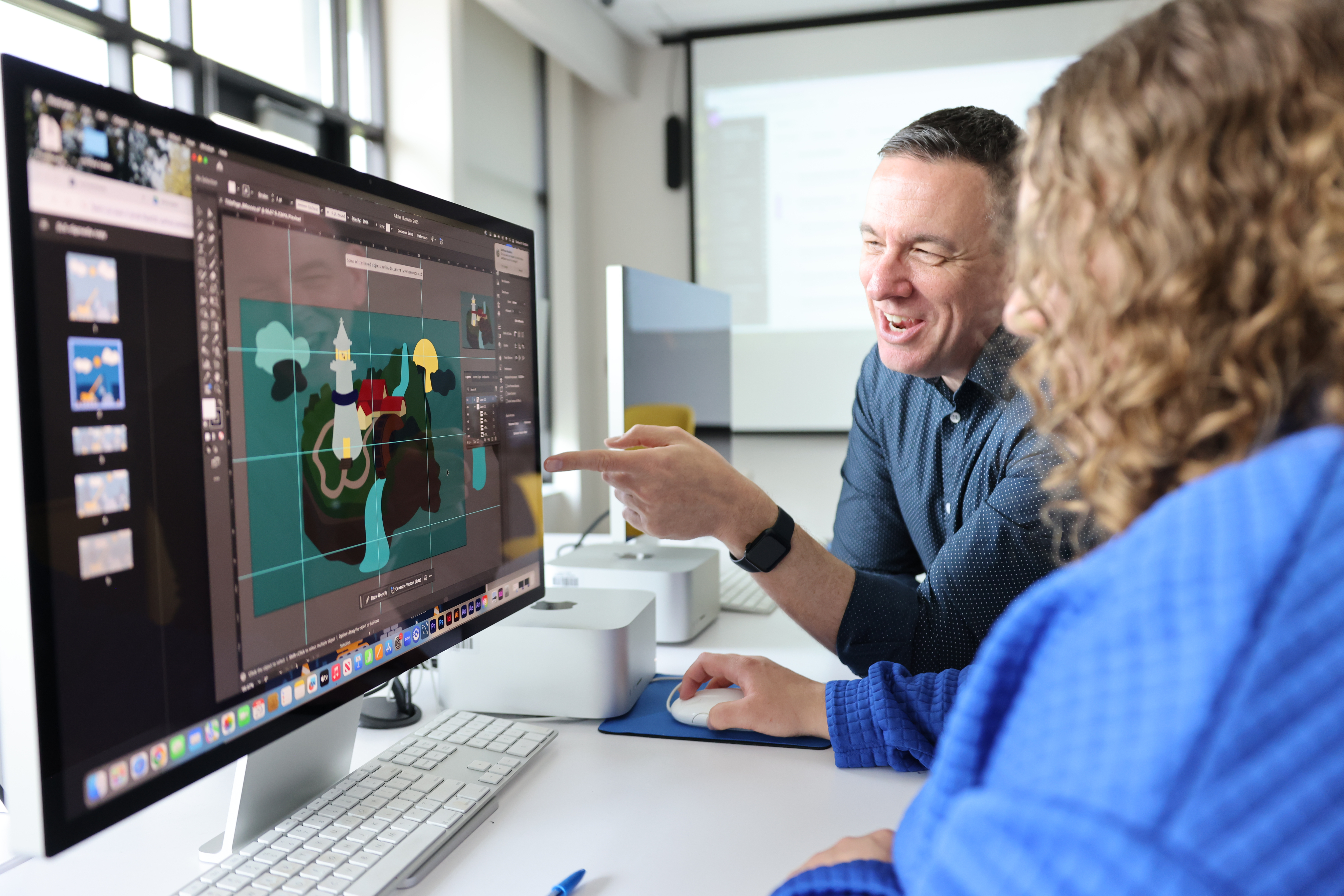 Teacher with student reviewing work on computer