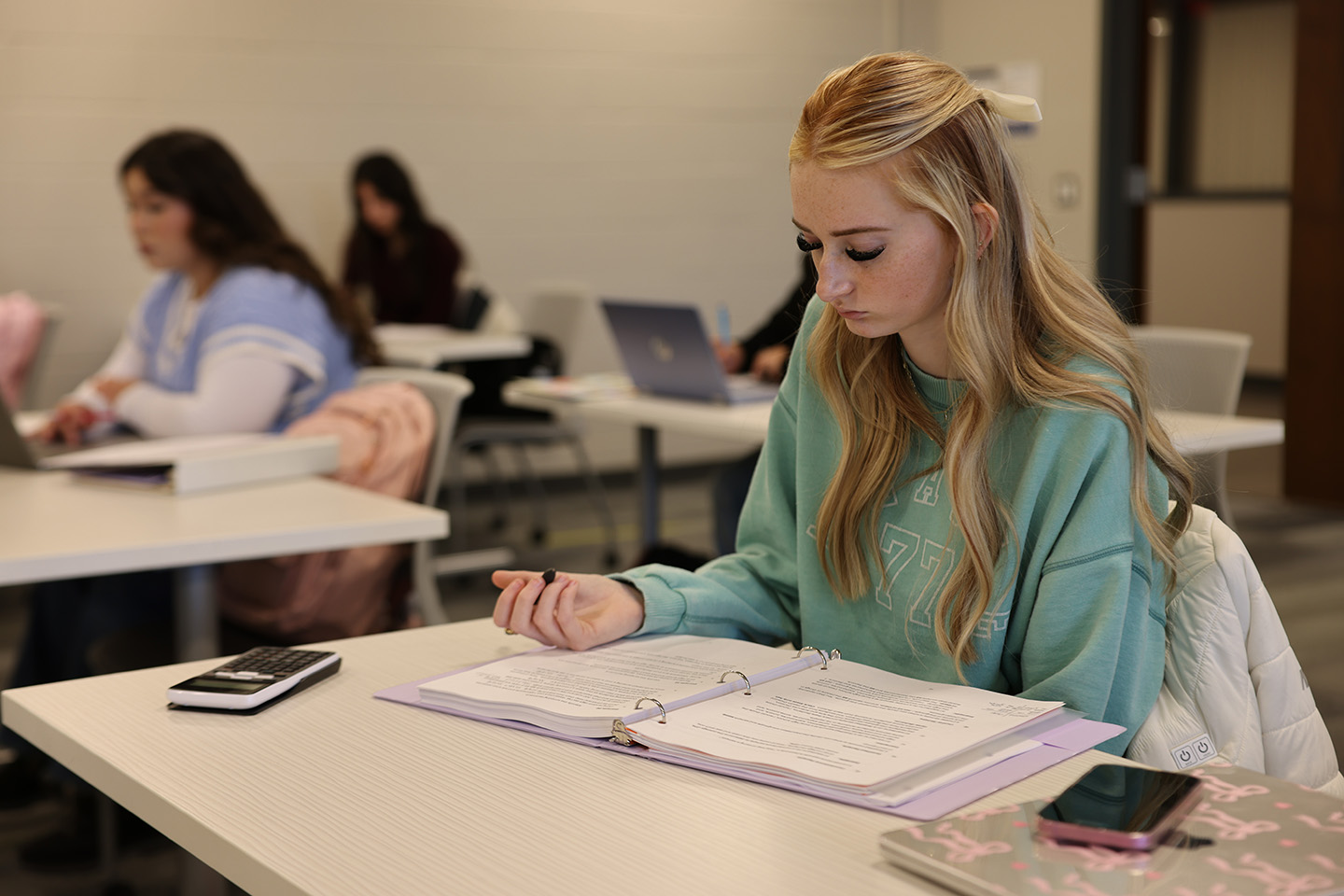 Student working on handouts in class