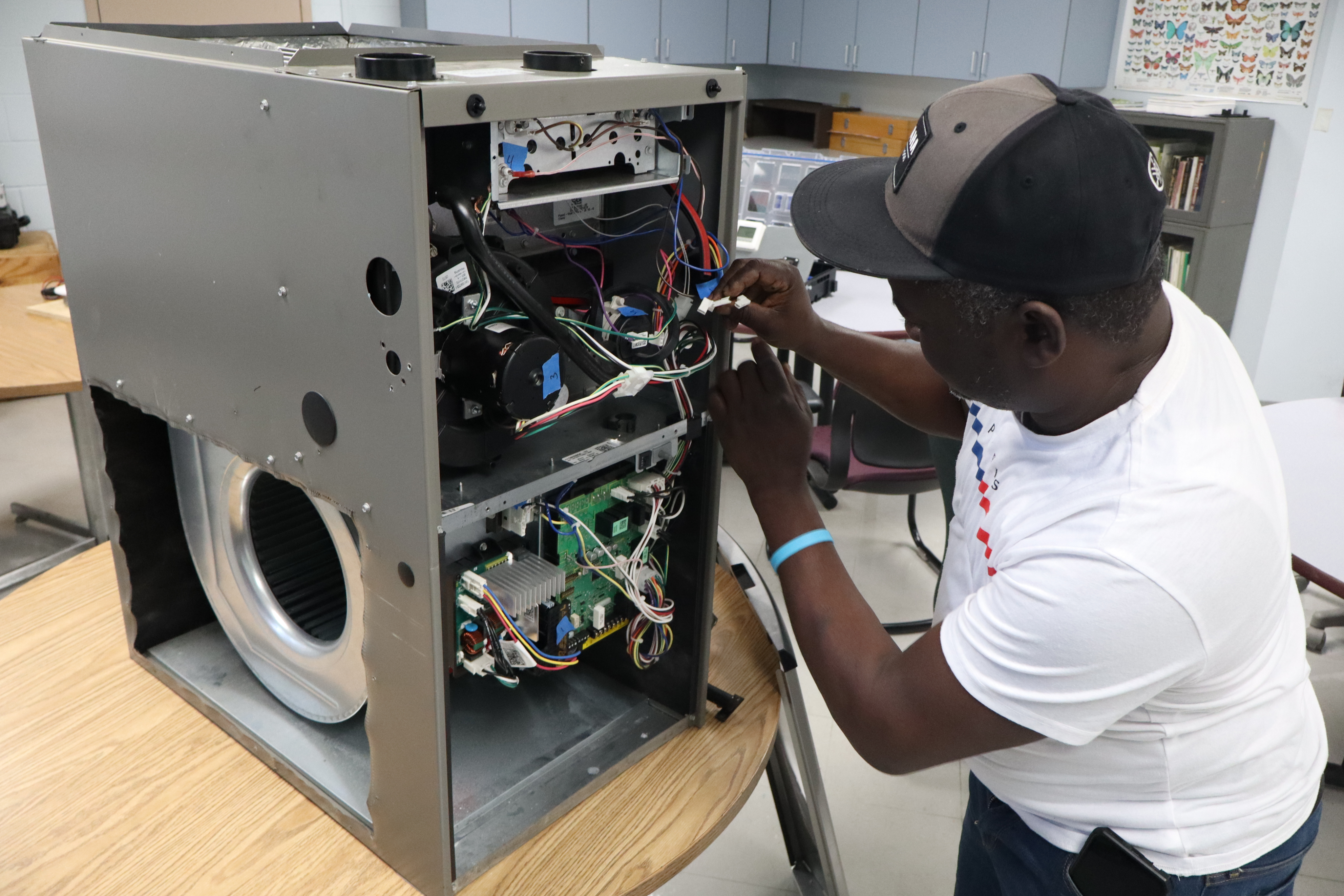 Student rewiring a mechanical system