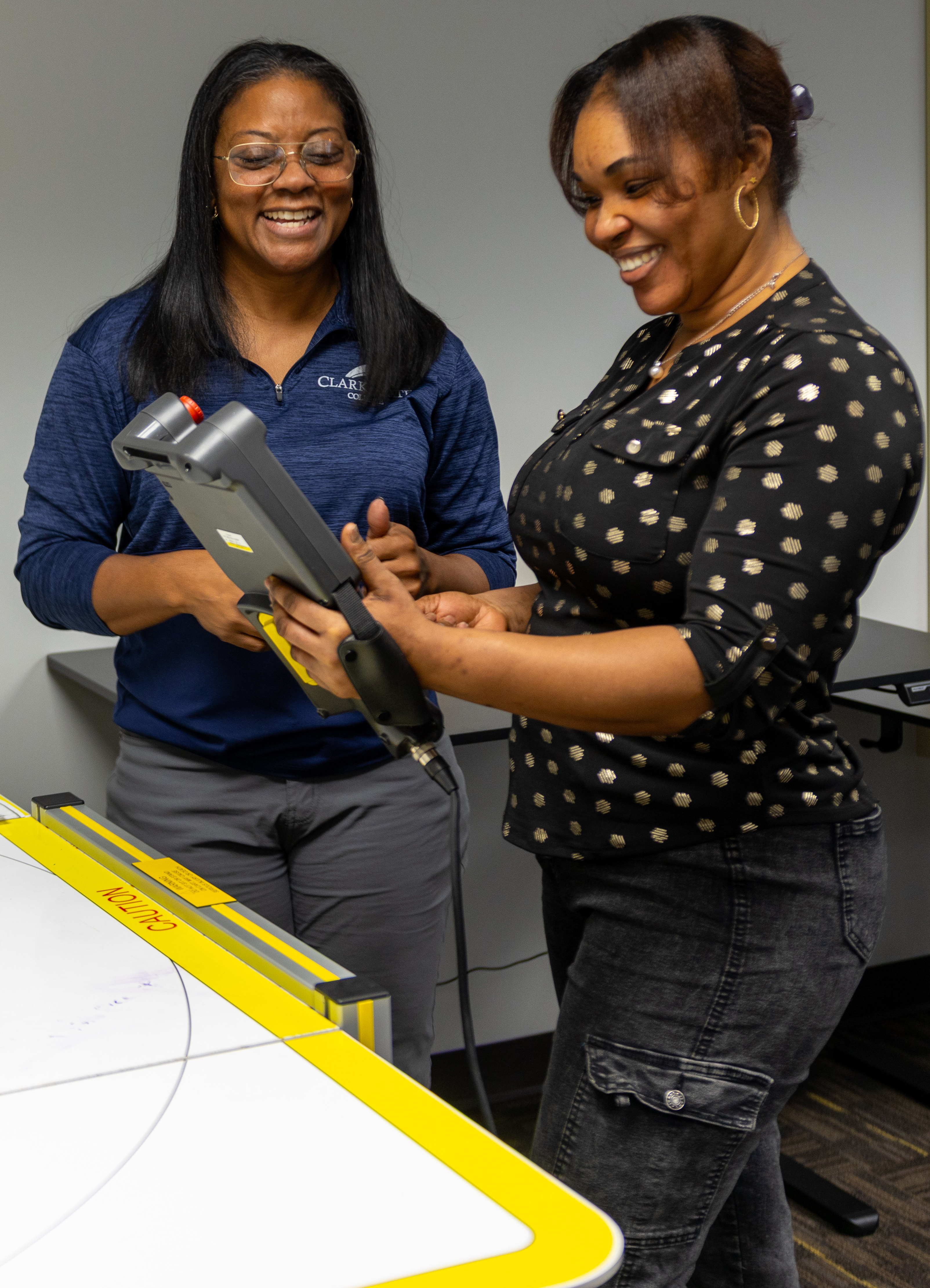 Two students look at manufacturing equiptment