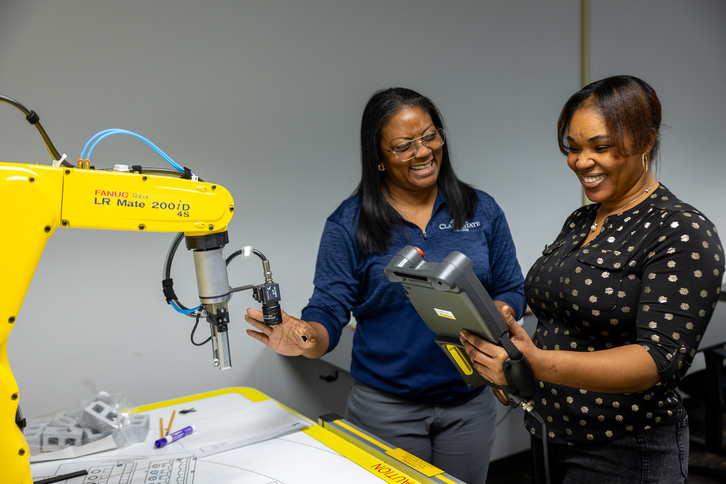 Two women work with engineering equipment