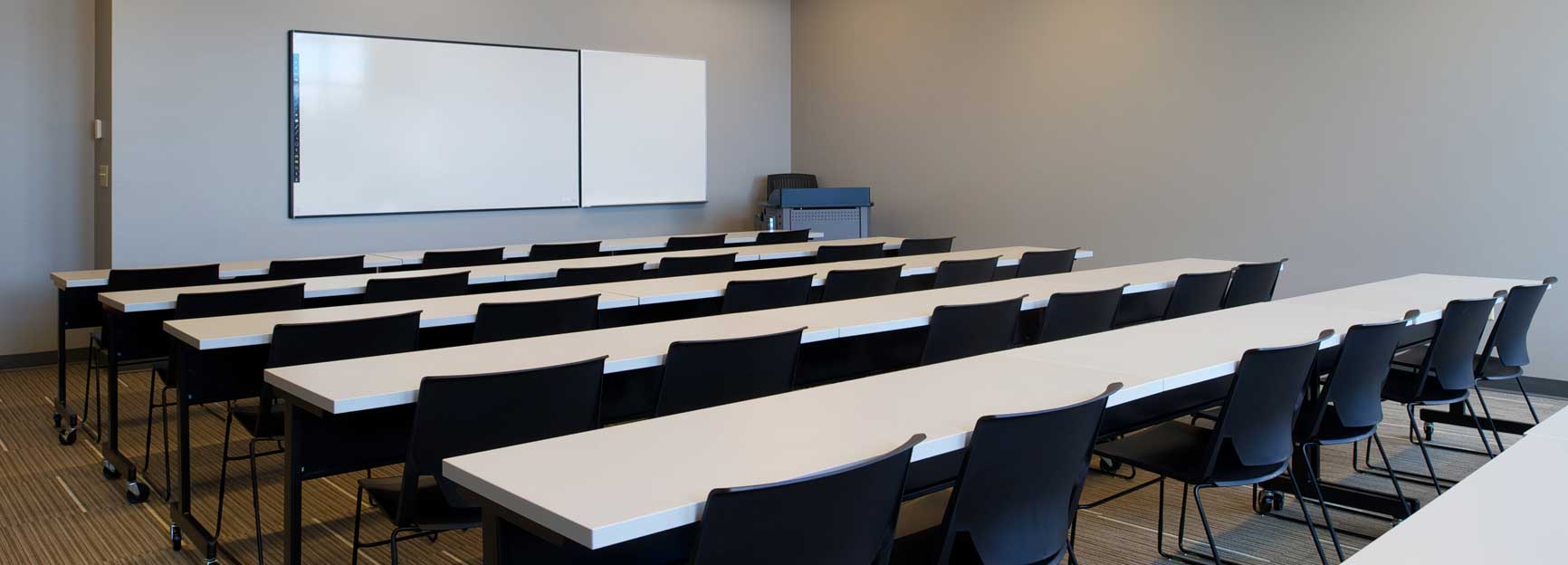 HBC Room 113; Rows of tables with chairs