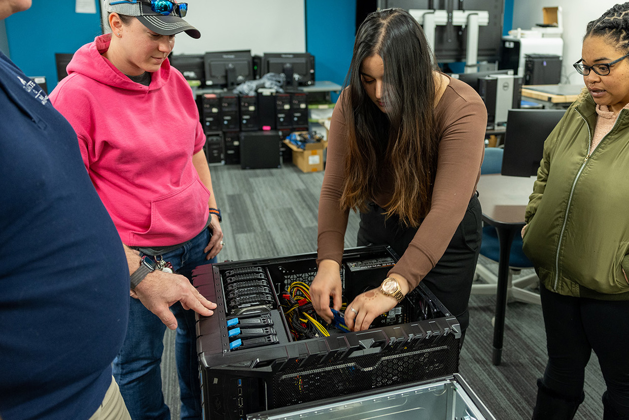 Students working to rewire a computer tower.