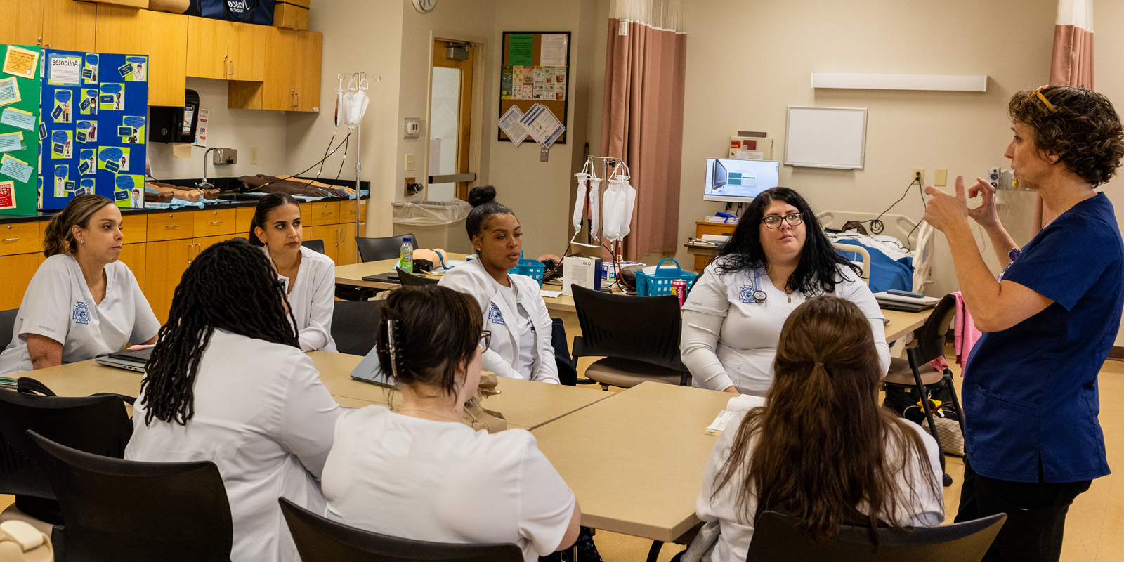 Student in scrubs in nursing course