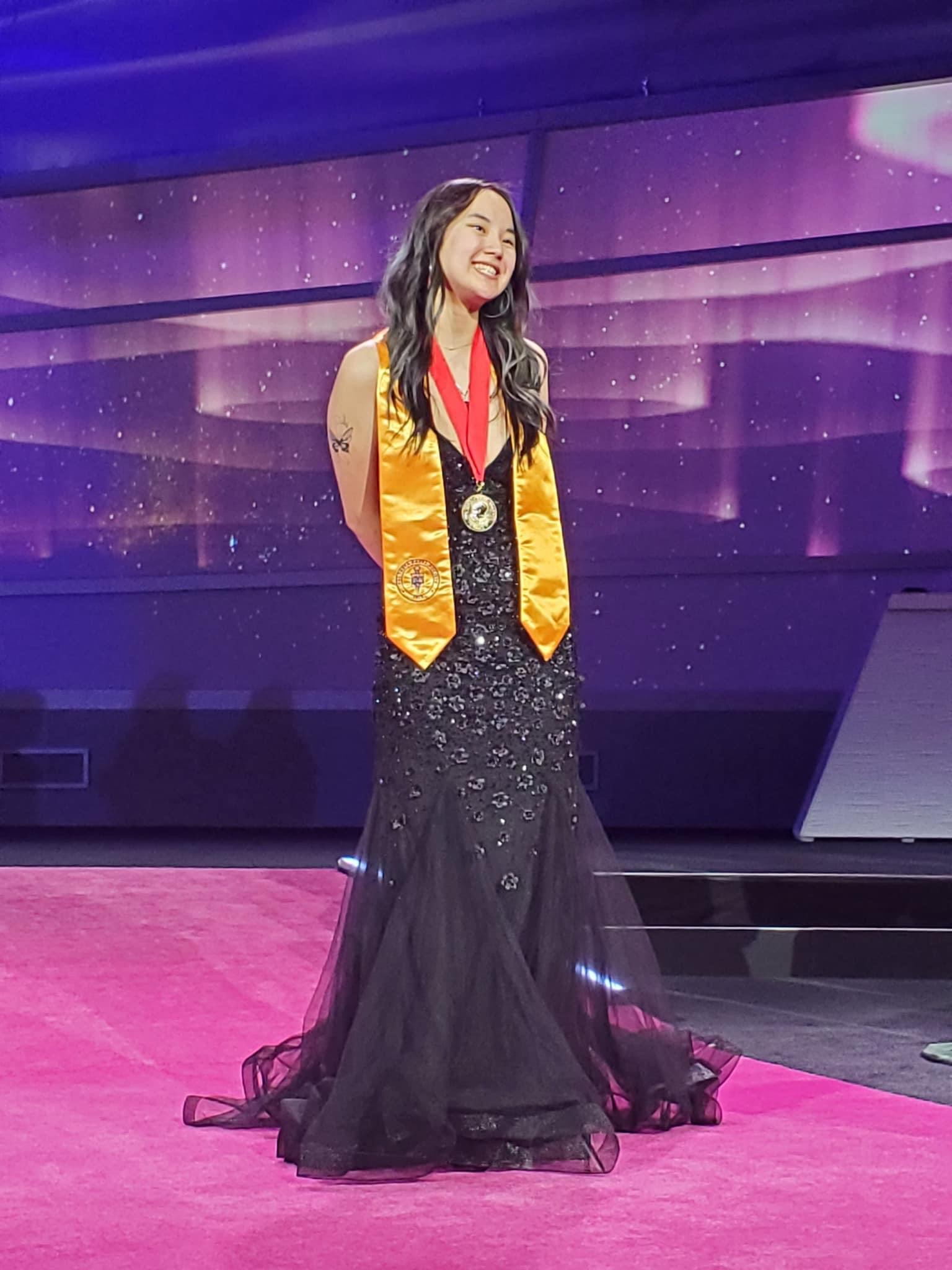 Annalise Smith wins PTK international president in blue gown with red medal