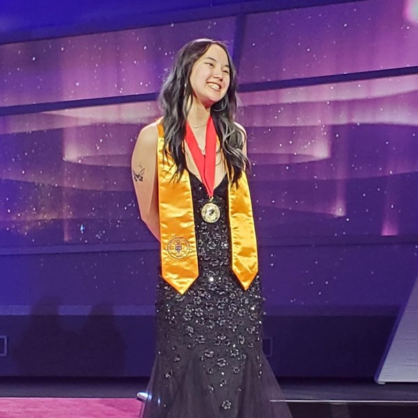 Annalise Smith wins PTK international president in blue gown with red medal