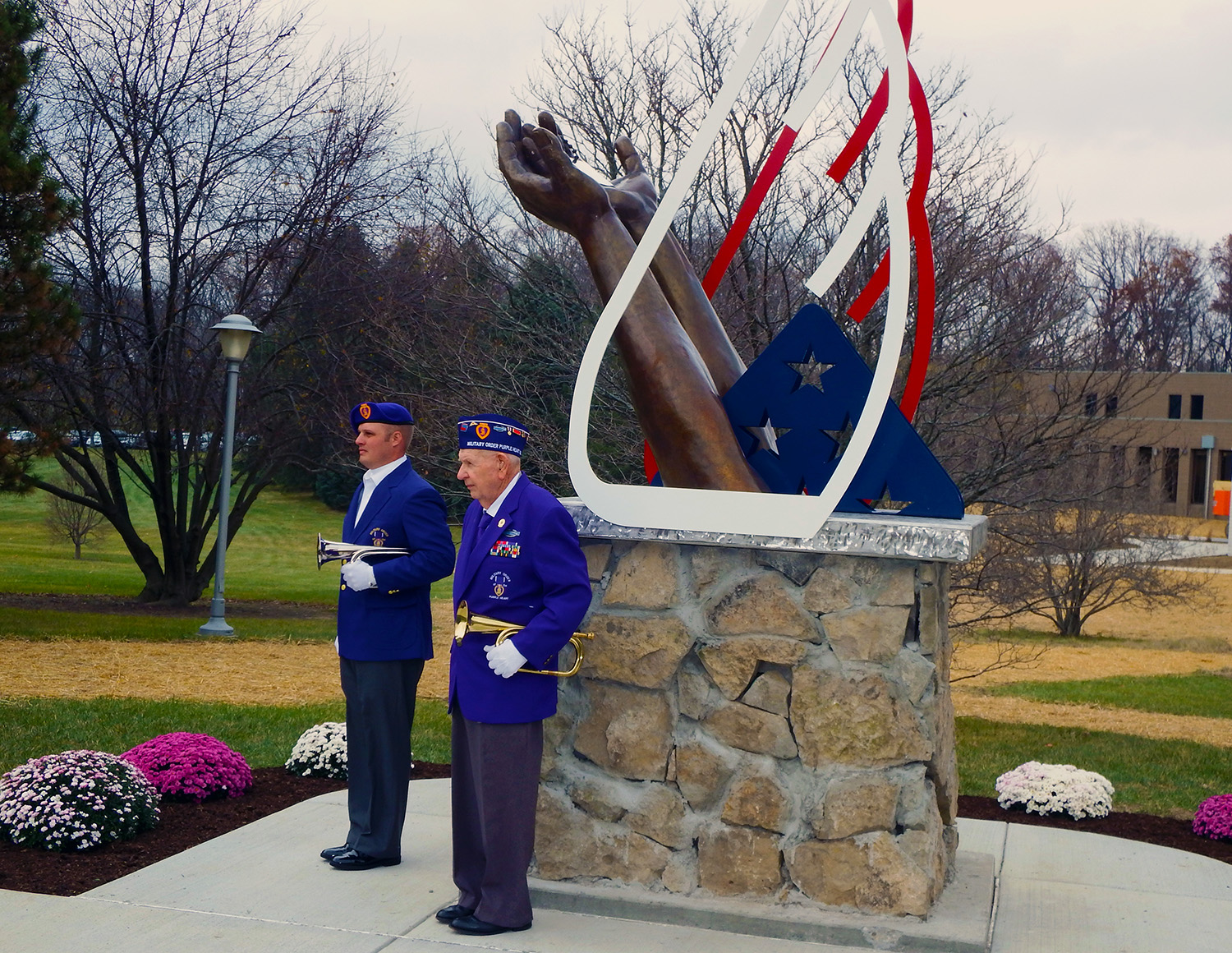 Two military members in front of Clark State's Fallen Warrior Memorial.