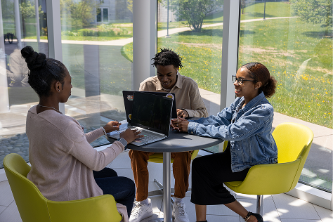 3 students studying at a table at lunch