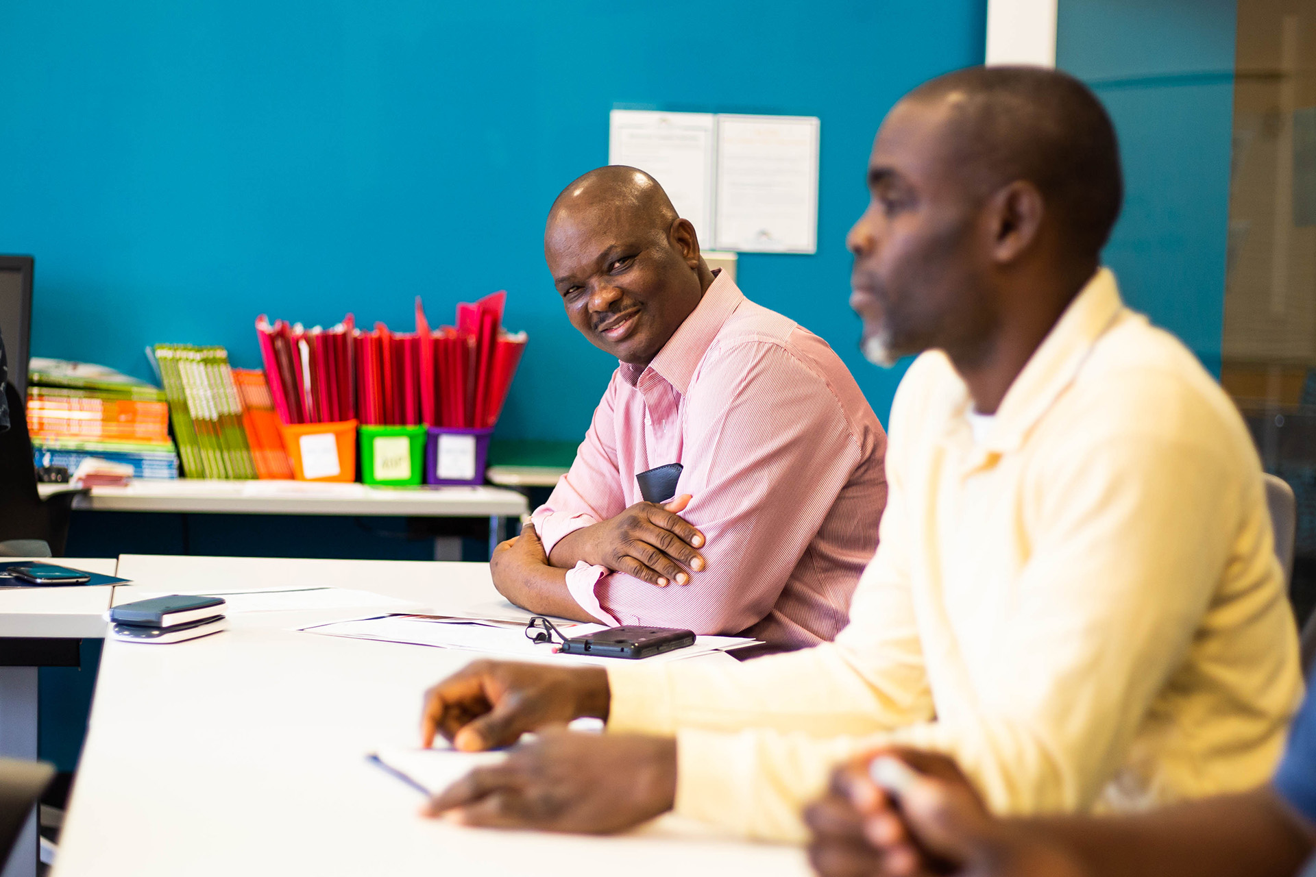 African American male student smiling in class.