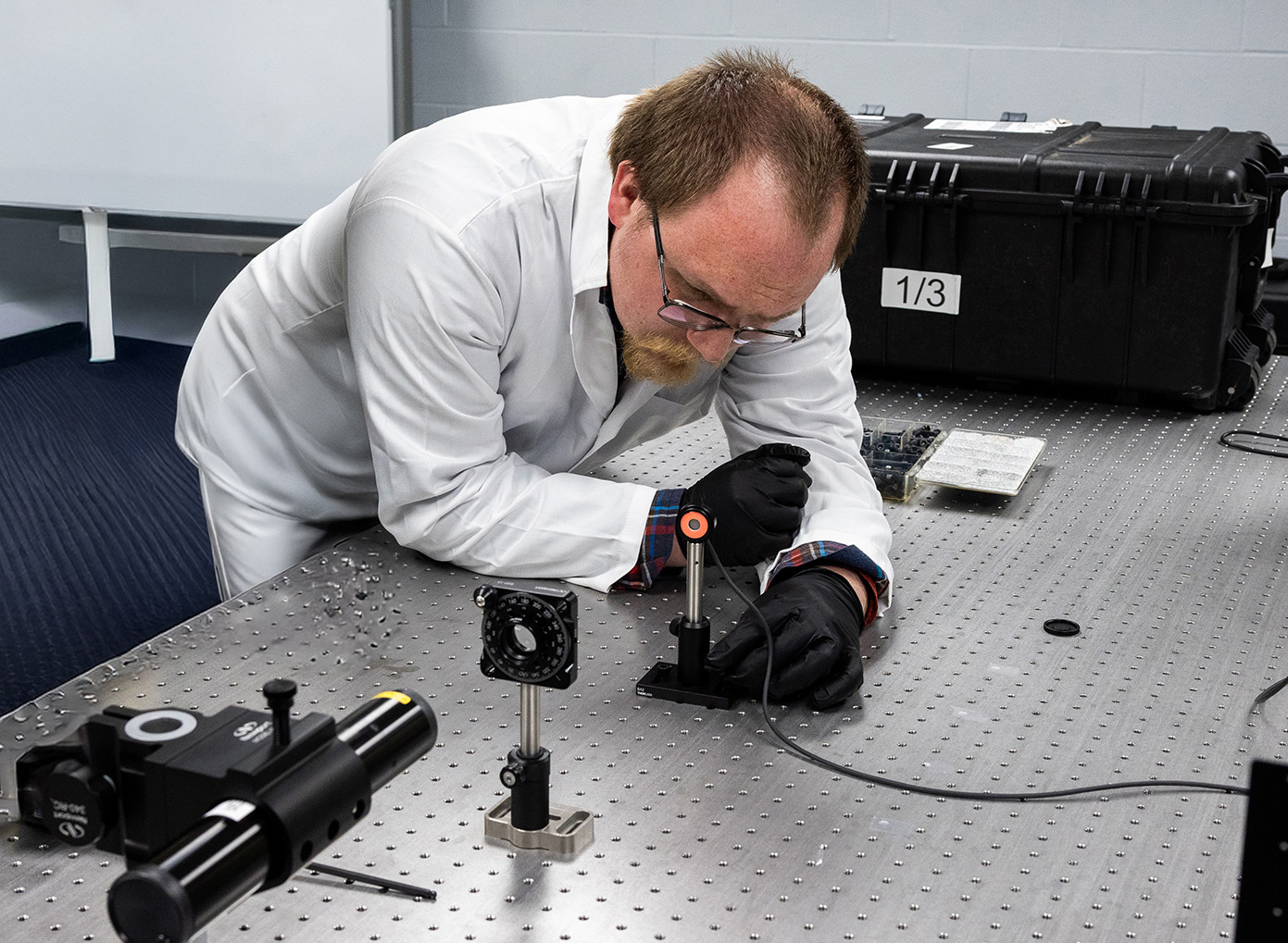 Student placing a laser on a table.