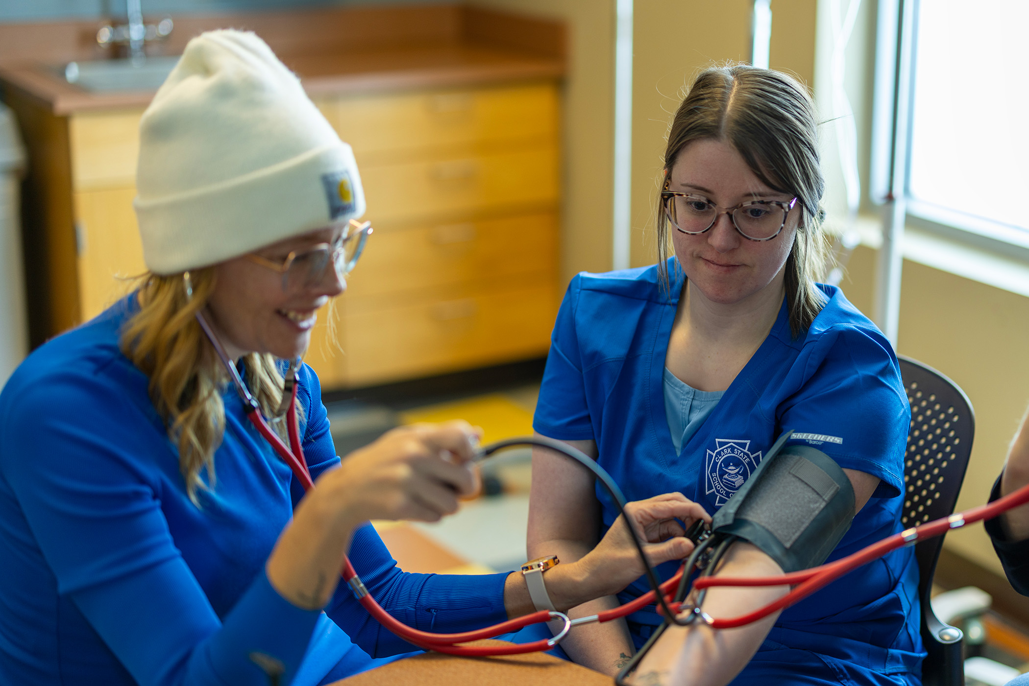 Student taking a women's blood pressure